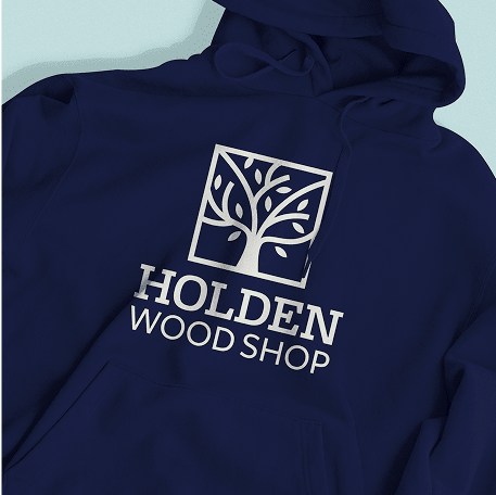 A navy blue hoodie featuring a printed logo of a stylized tree inside a square frame, with the text 'HOLDEN WOOD SHOP' beneath it in bold white letters.