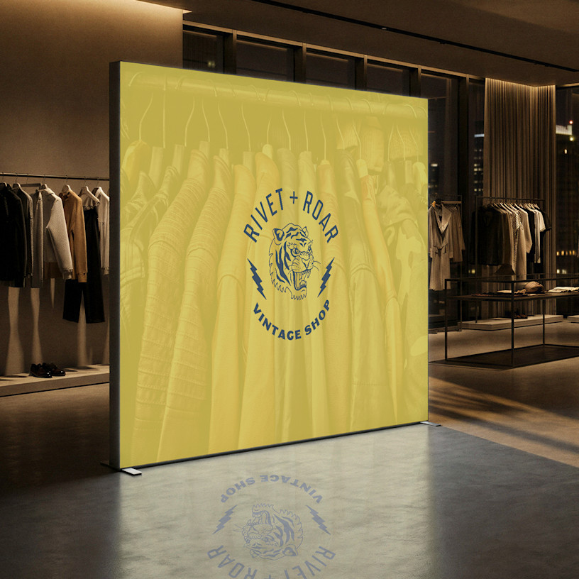 A illuminated lightbox display wall promoting a vintage shop, displayed in-stores.  