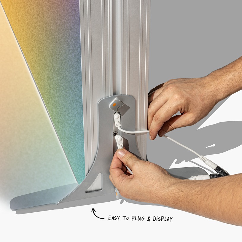 A closeup of the lightbox display wall's corner. An arrow points to the plug. 