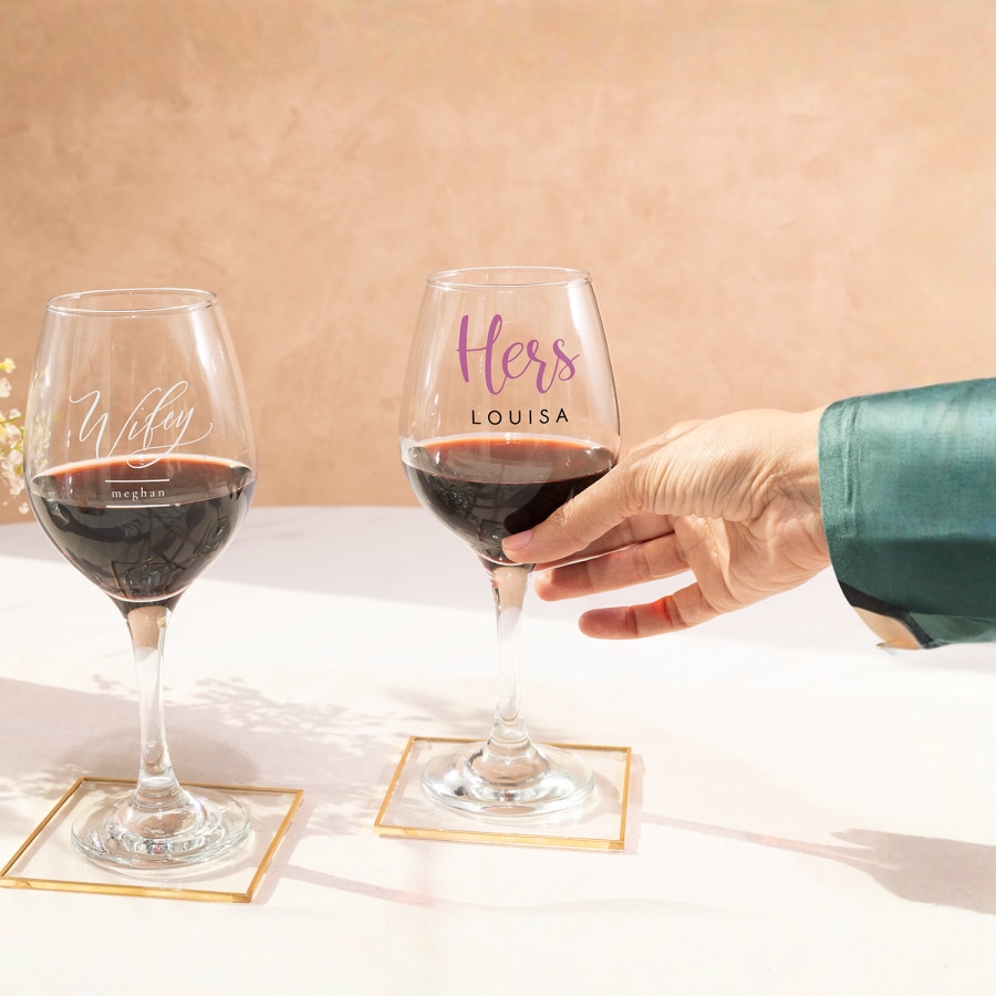 Two wine glasses personalised for a wedding.