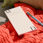 A personalised notepad with a space-themed design.