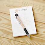 Branded notepads promoting a fashion brand.