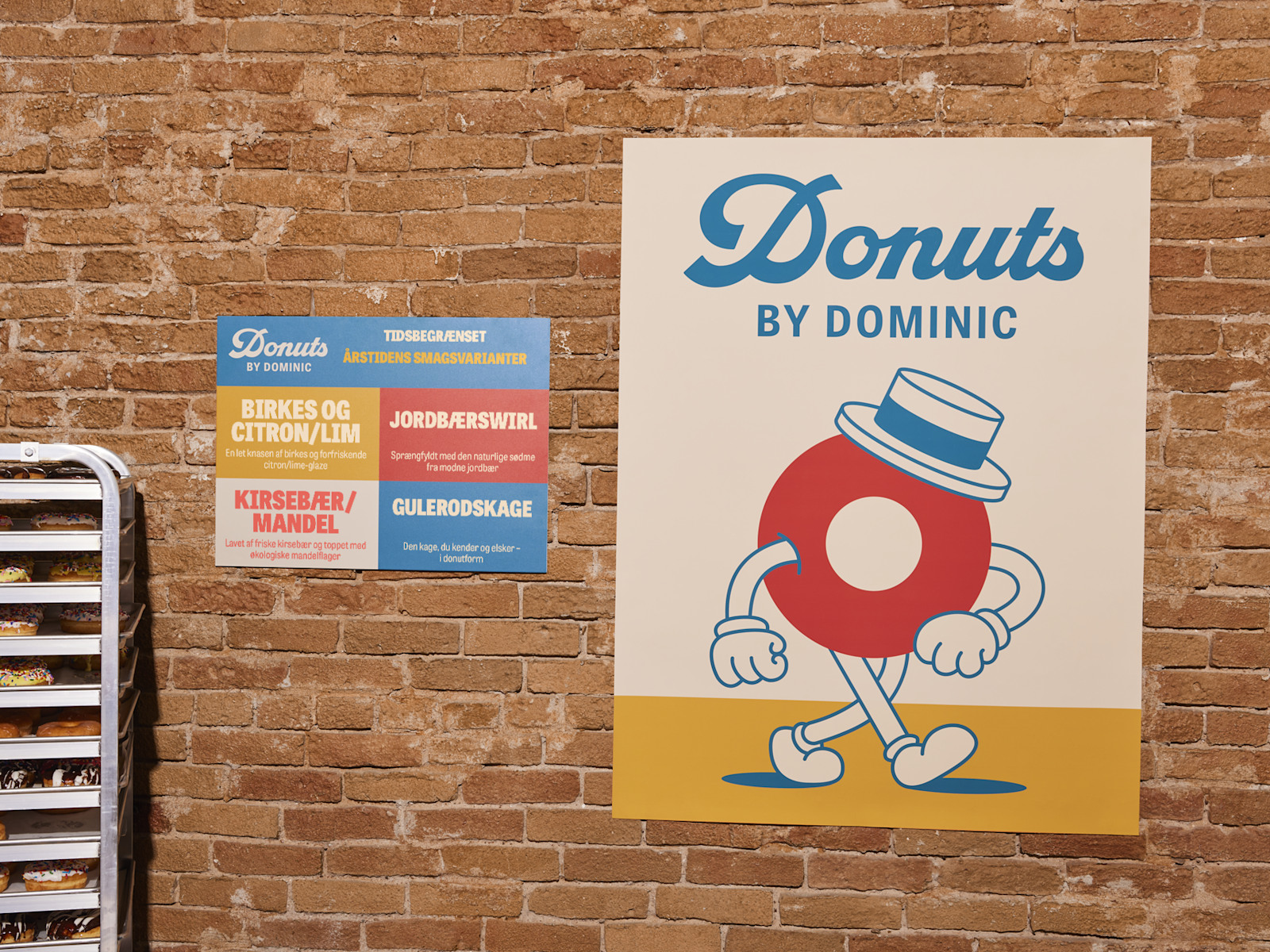 To plakater fra en donutvirksomhed sammen med et par friske donuts.