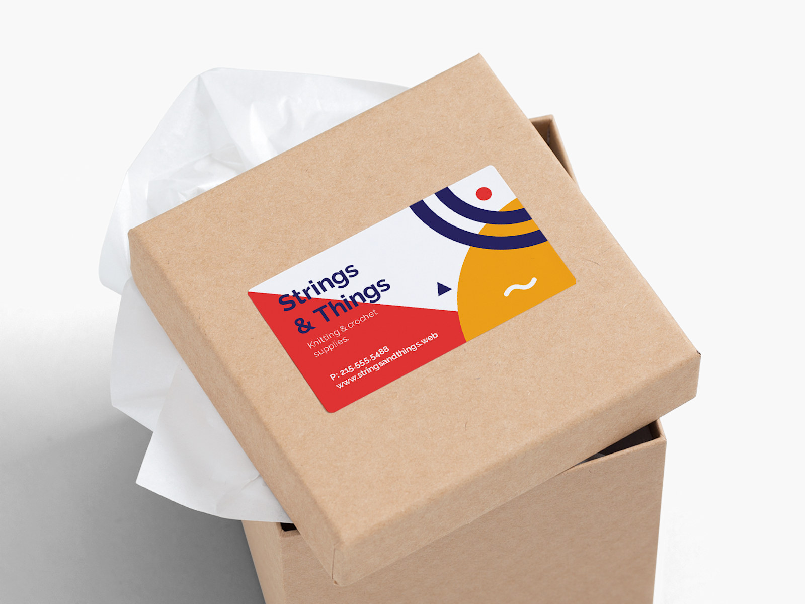 A packaging with a business card sticker on the top promoting a knitting and crochet supplies business.