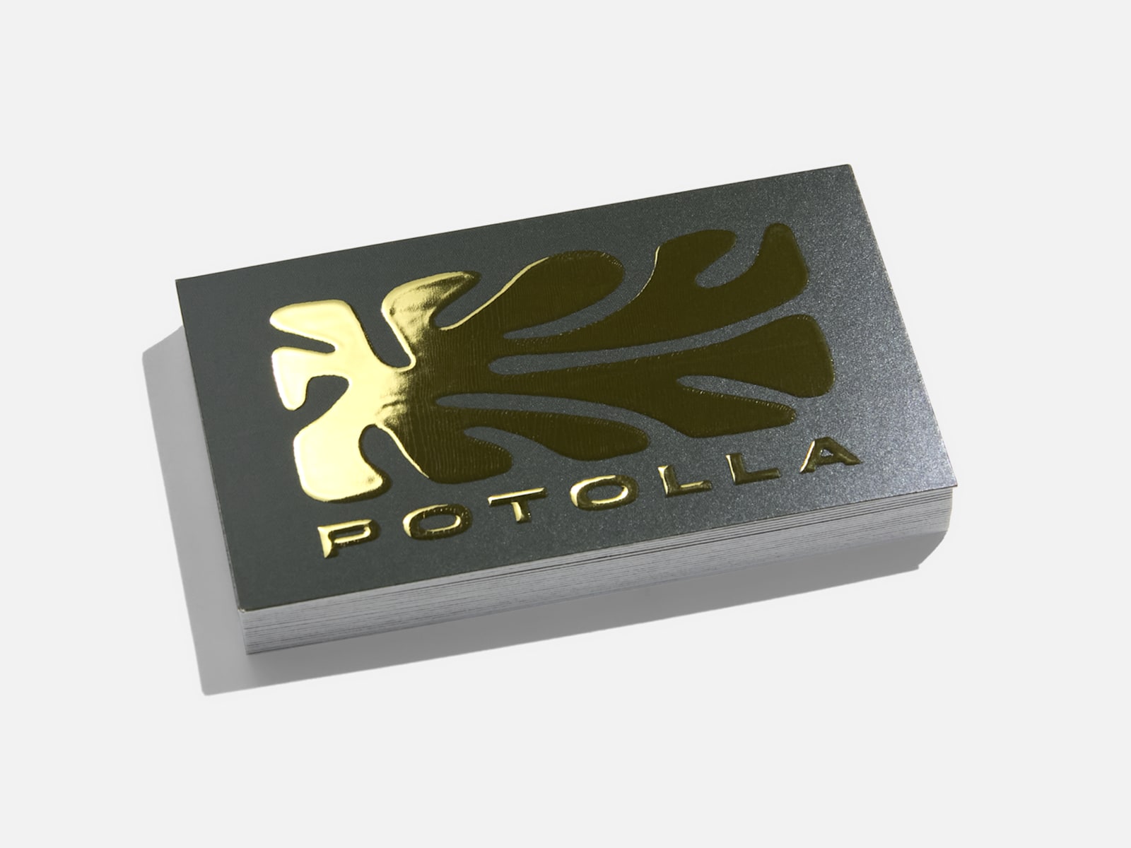 A business card printed with a raised foil logo and text.