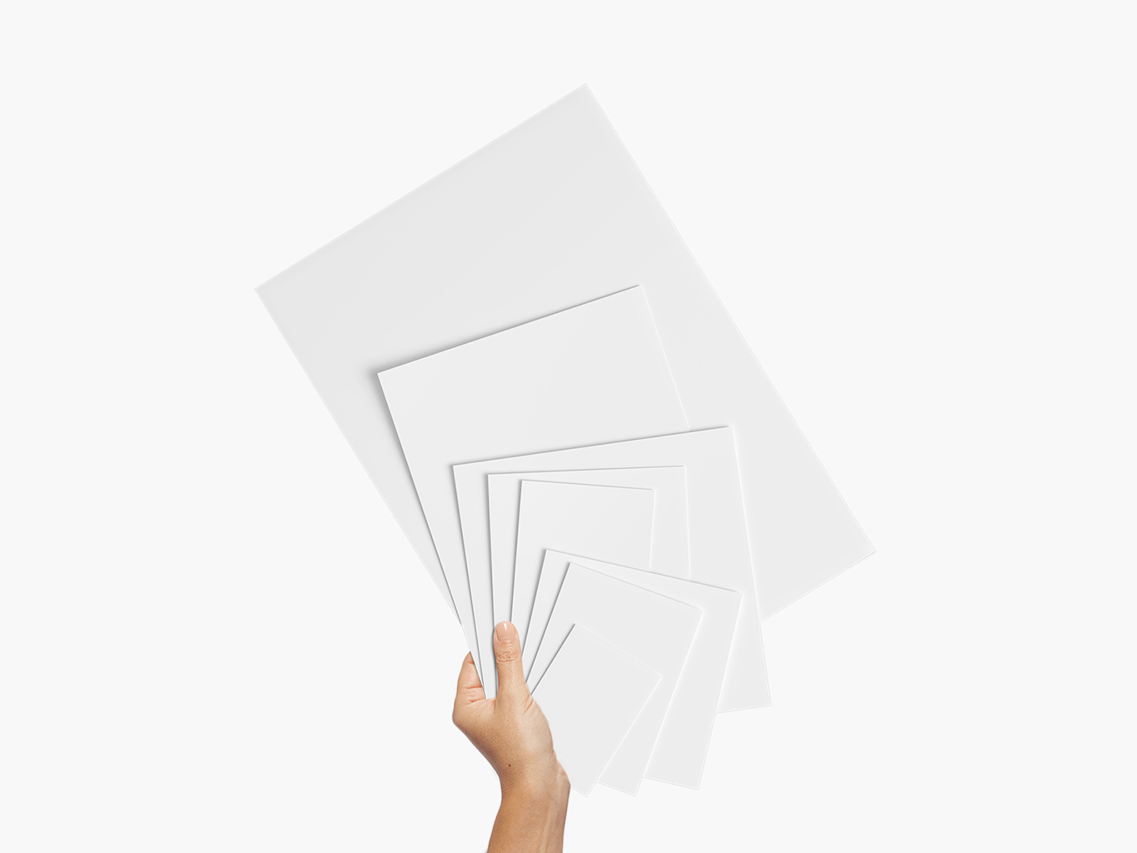 A hand holding a stack of blank flyers in 8 different sizes.  