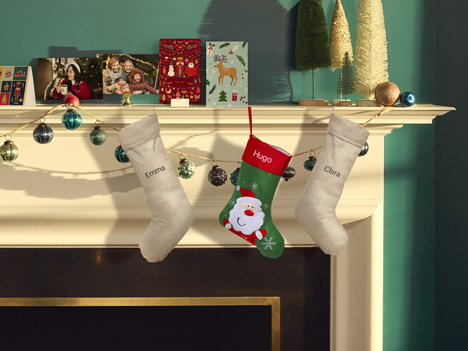 Three customised Christmas stockings hanging on the fireplace mantelpiece.