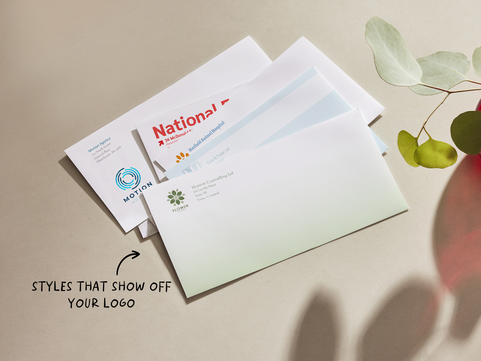 Custom DL envelopes showing different business designs. There is text that says envelopes come in different styles to show off your logo