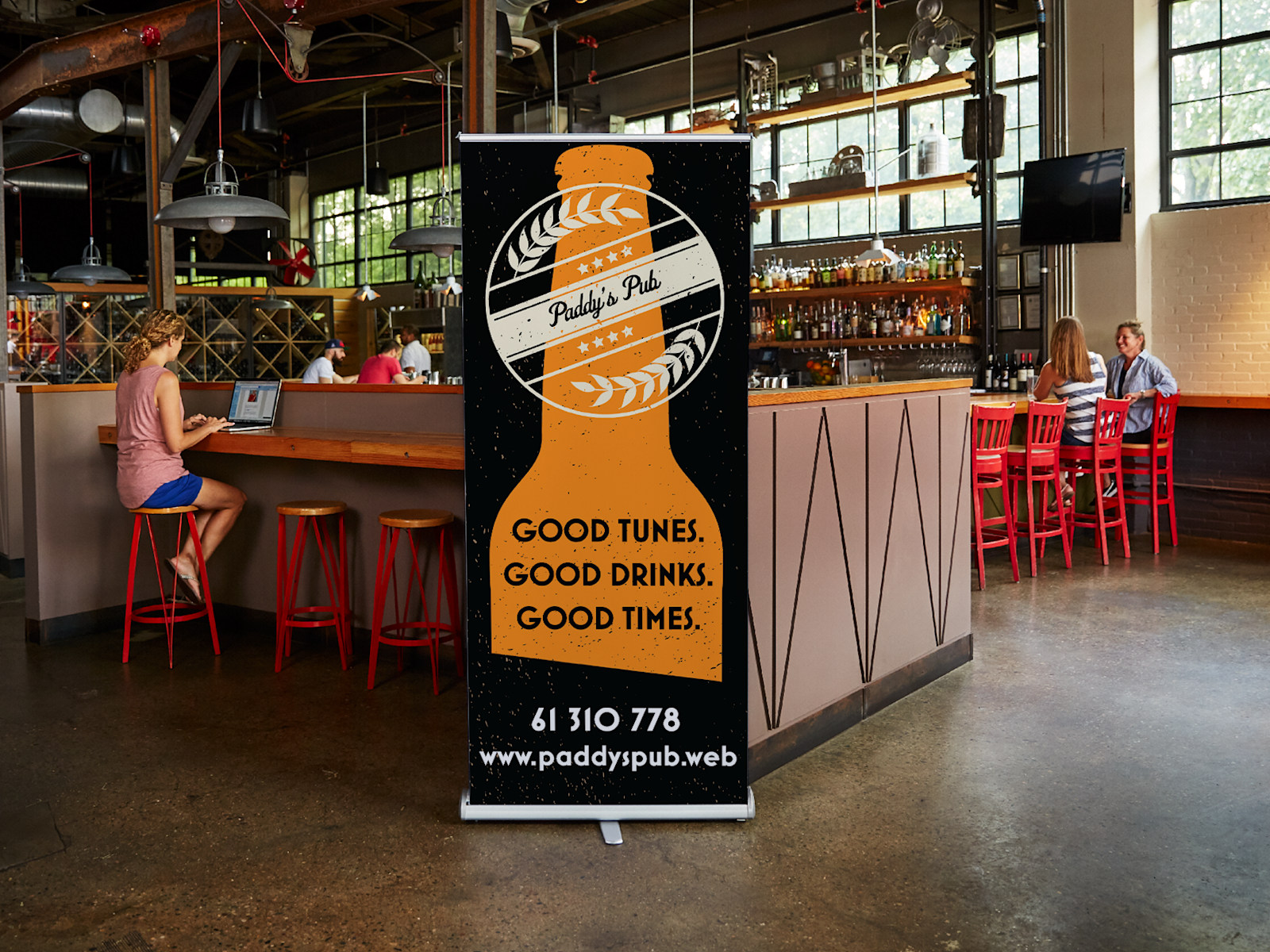 Roll-up banner advertising a pub, placed right in front of the bar.