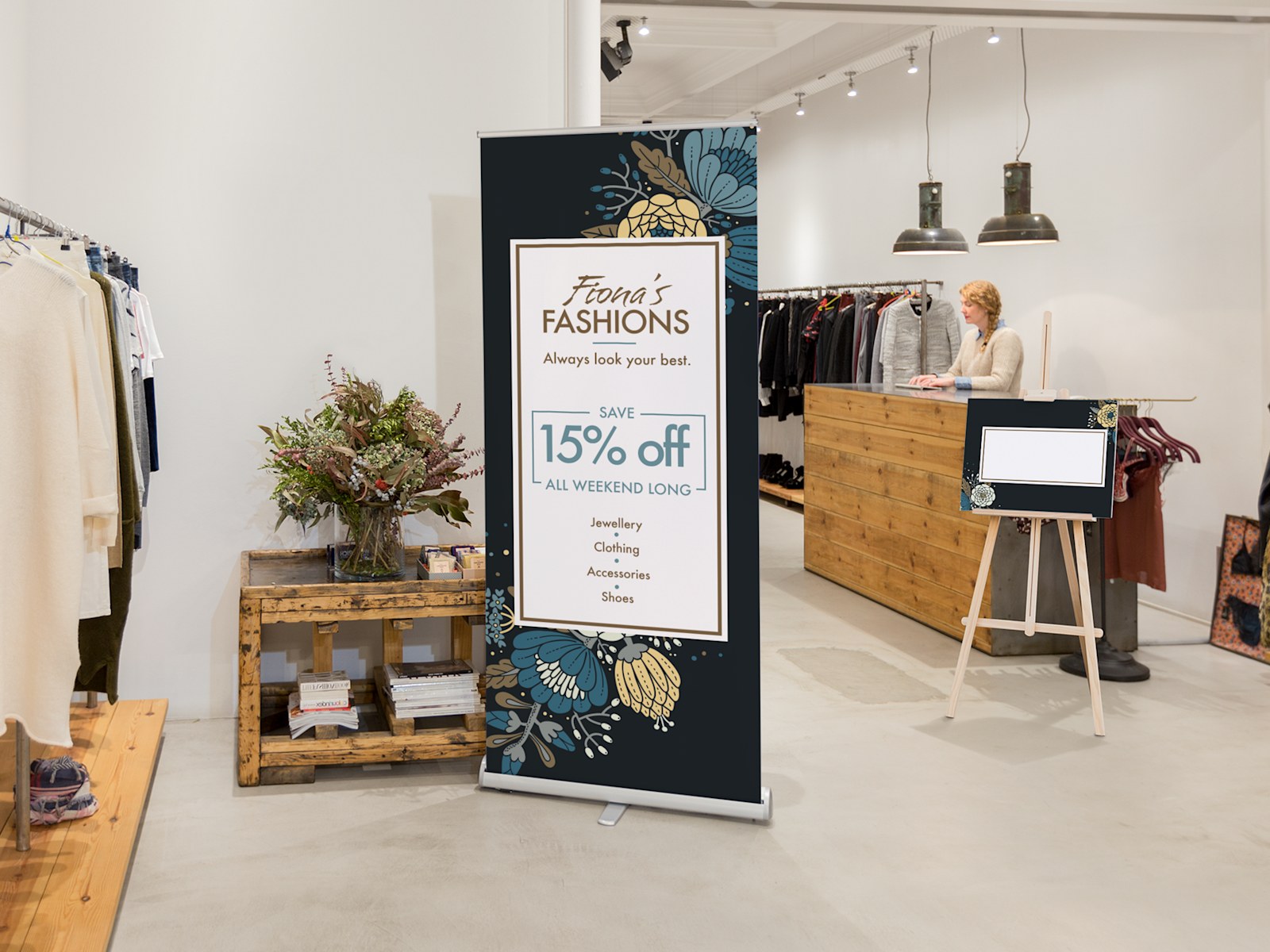 Roller banner placed inside a boutique, advertising their seasonal sale. 