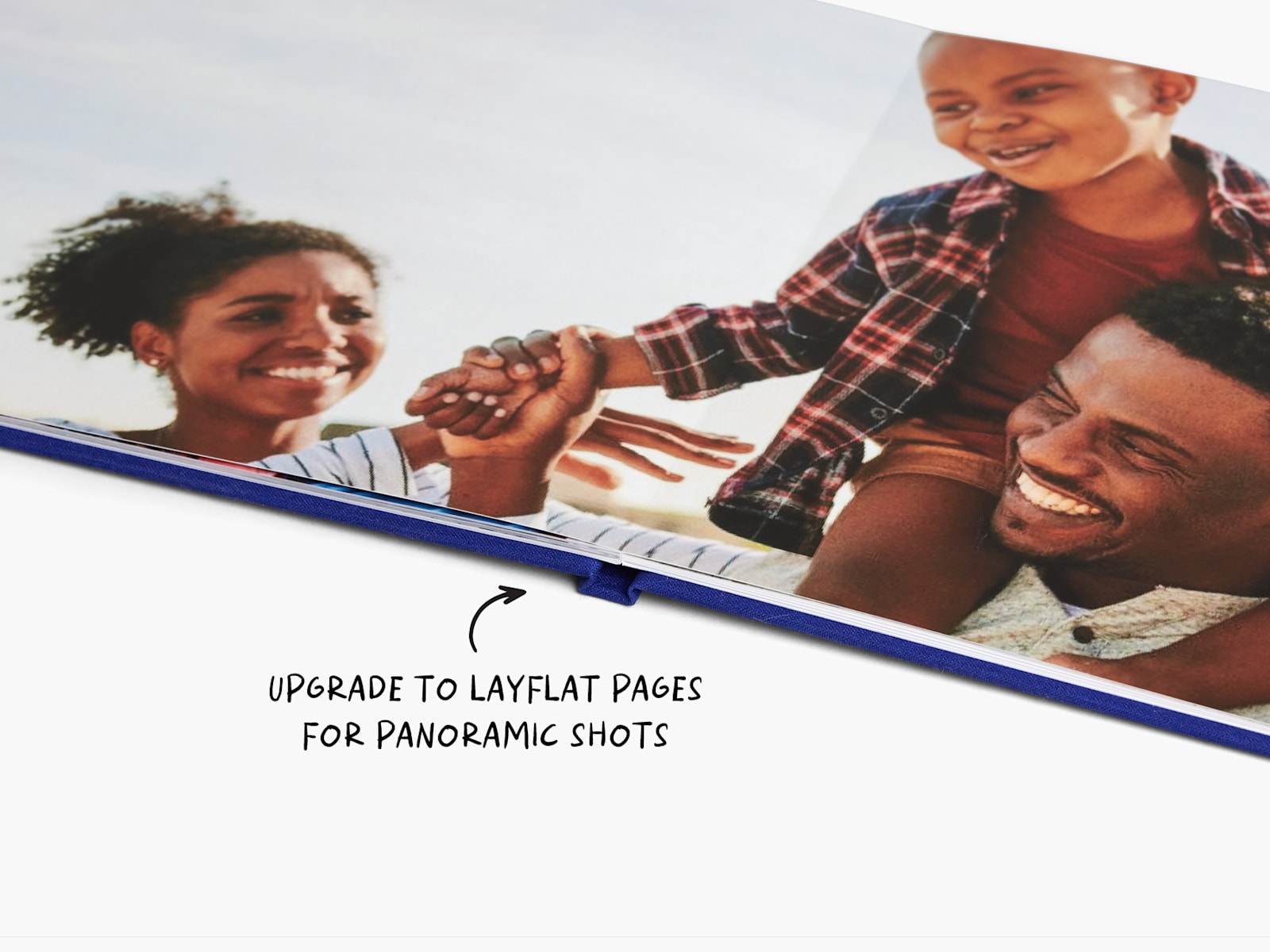 An open photo book that features layflat pages, with a note that says you can upgrade to layflat pages for panoramic shots.