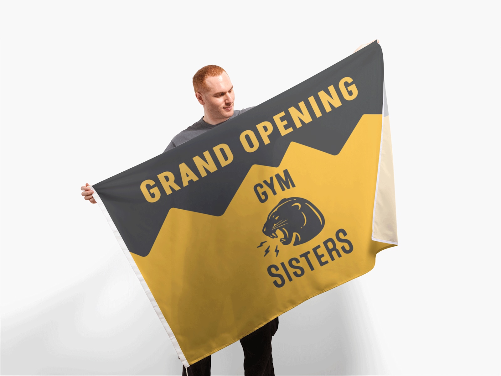 A man holding a large flag for his gym’s grand opening.