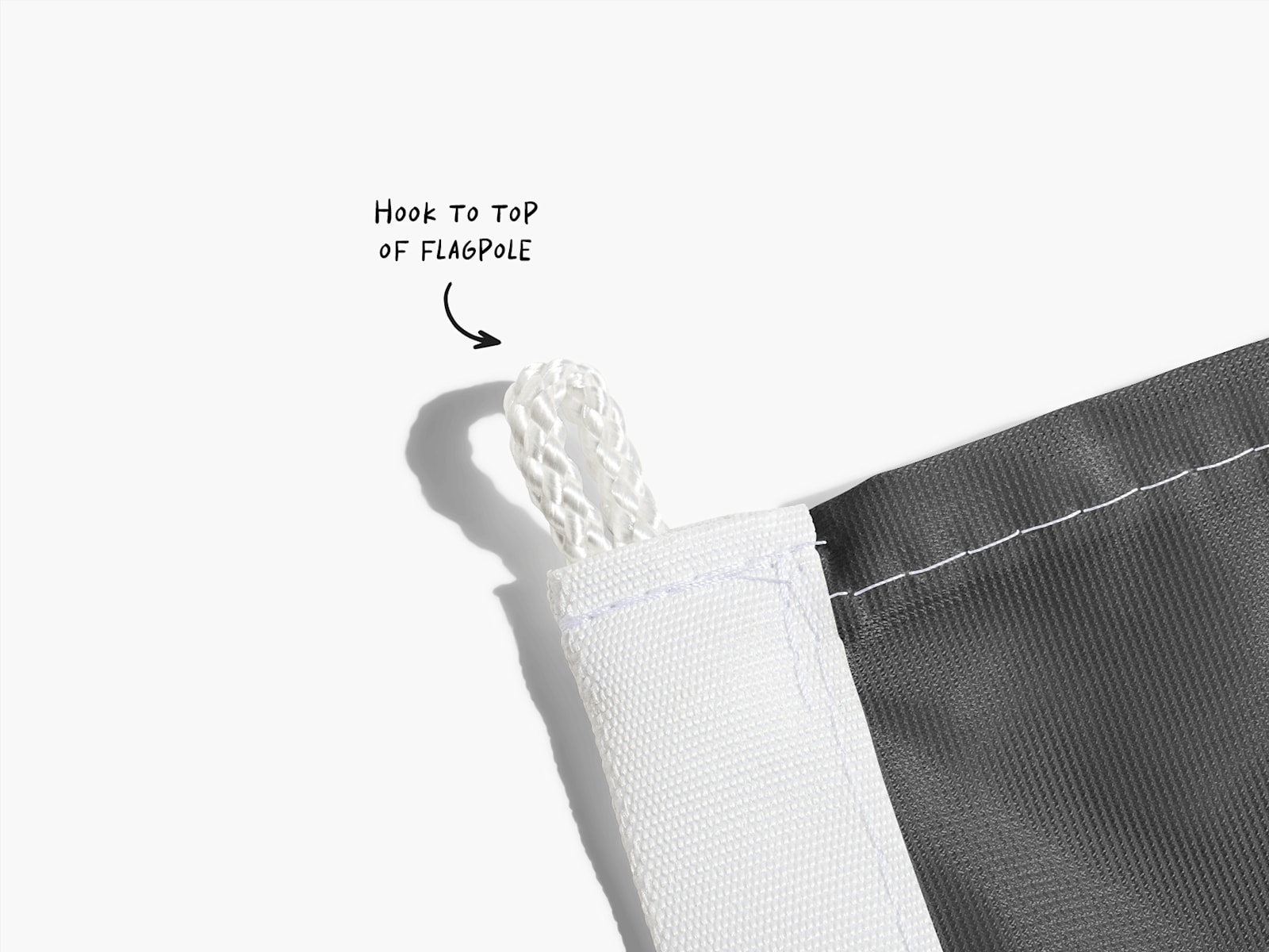 A close-up of a flag’s top string loop, with a note saying to attach this part to the flagpole.