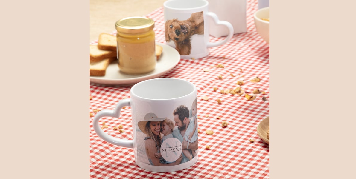 Two heart-shaped handle mugs at a breakfast table. 