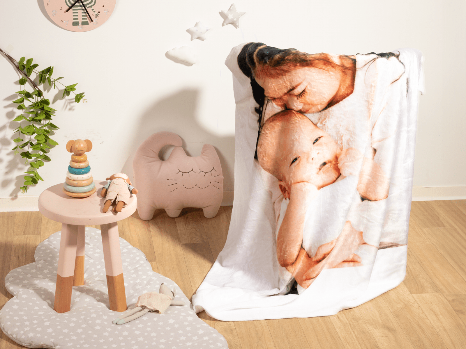 A custom photo blanket shows the image of a young child holding an infant.