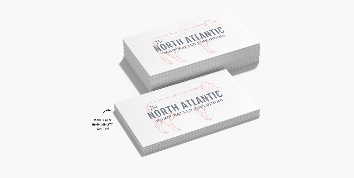 Business cards for a fine-dining restaurant with a note that they’re made of thick, 18pt cotton paper.