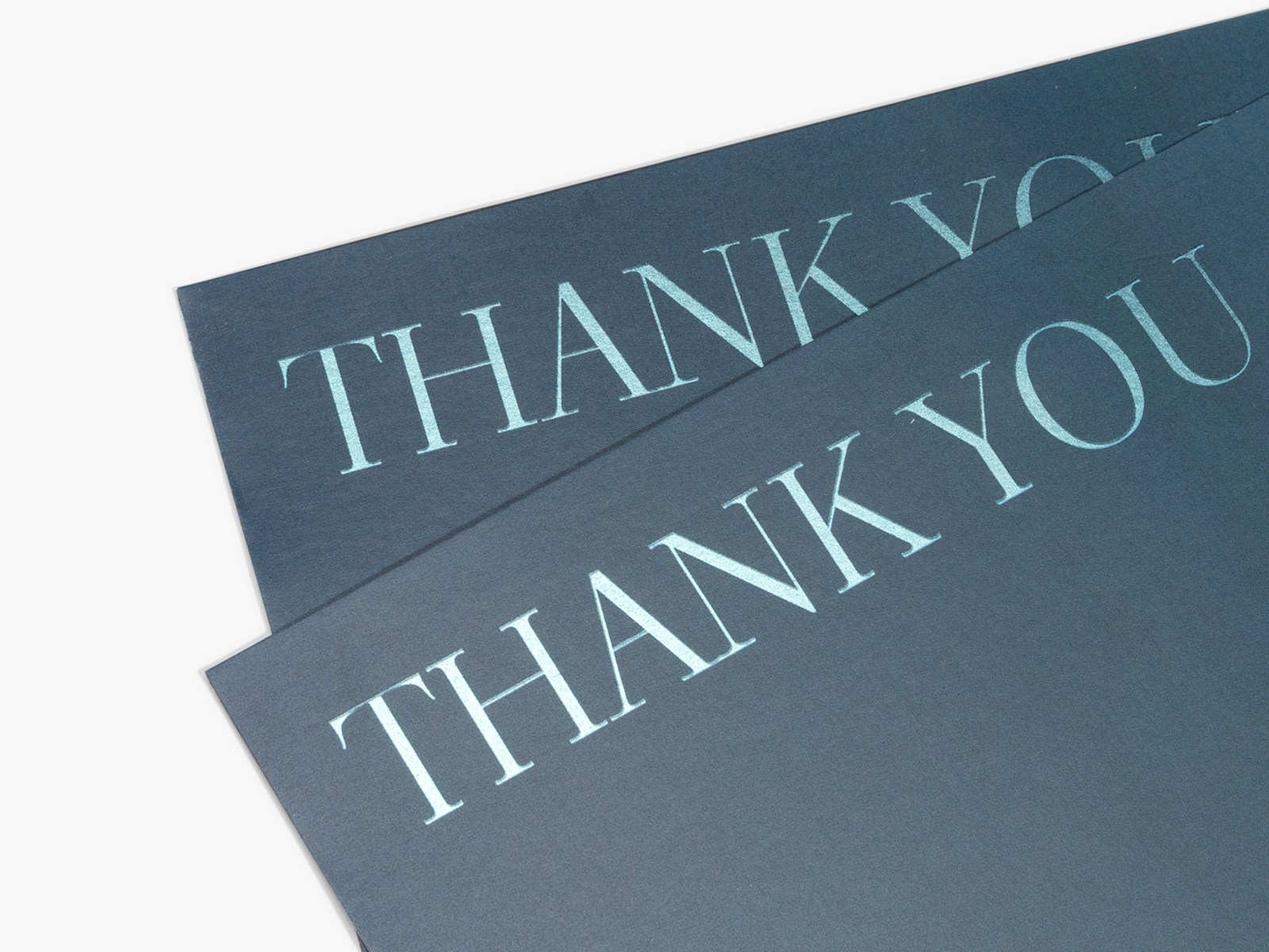 Two foil accent postcards with the words “thank you” written on the front.