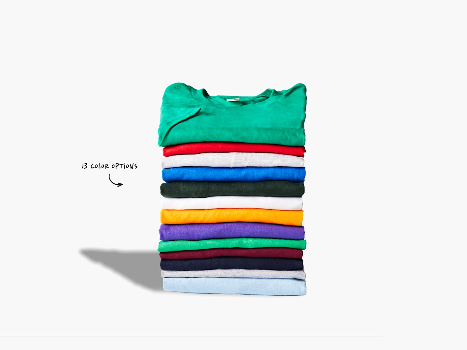 A pile of folded T-shirts in various colors, with a note that there are 13 color options. 