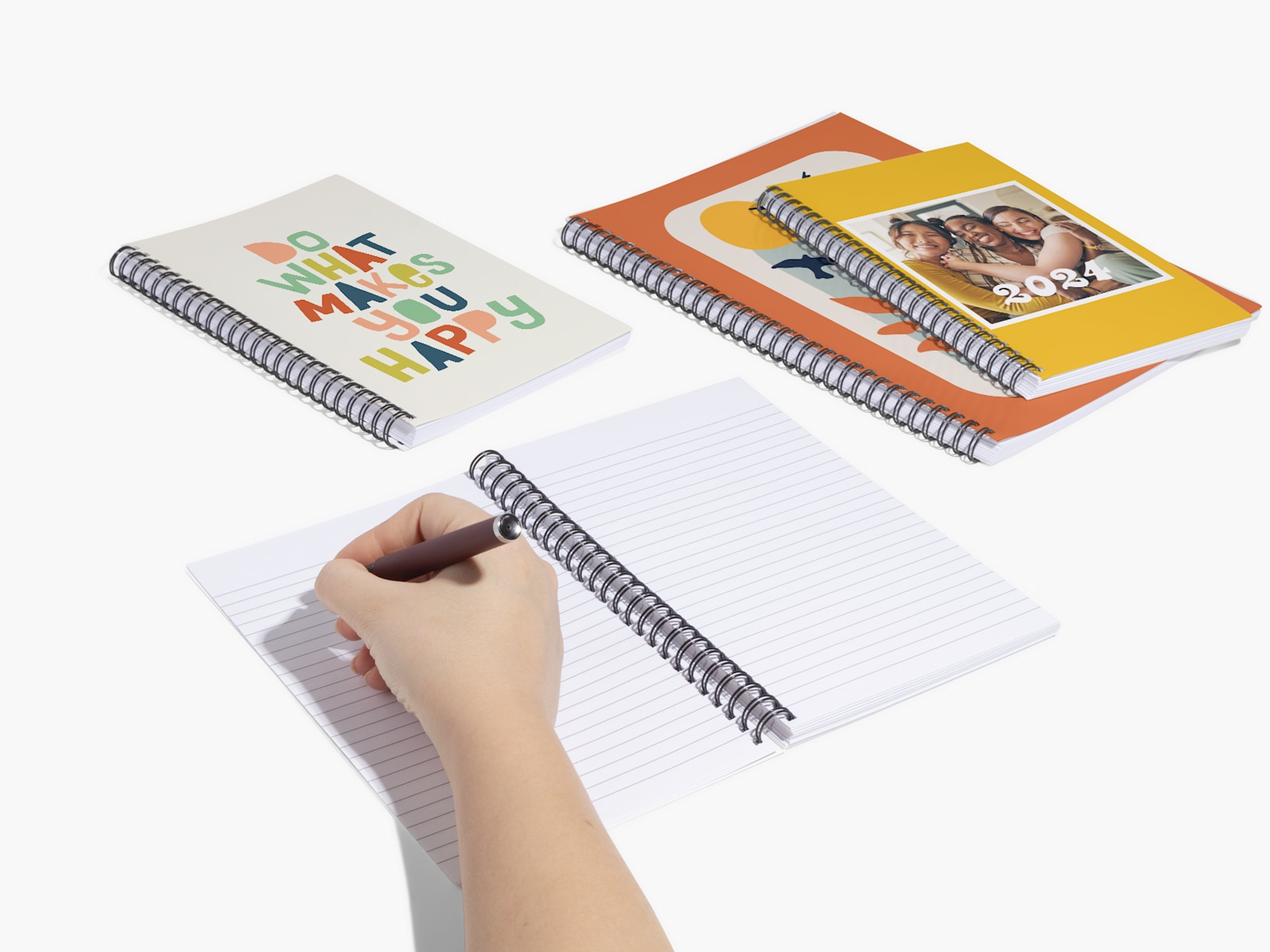 Several custom notebooks featuring photographs and art on the cover.