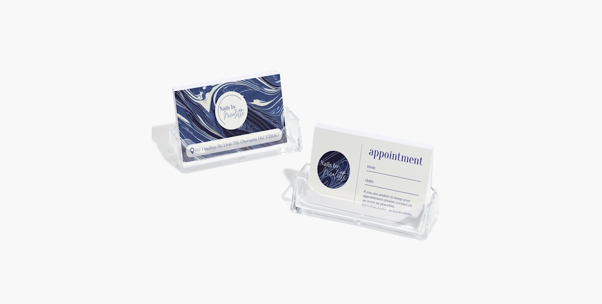 Larger version: Two acrylic business card holders holding appointment reminder cards for a nail salon.