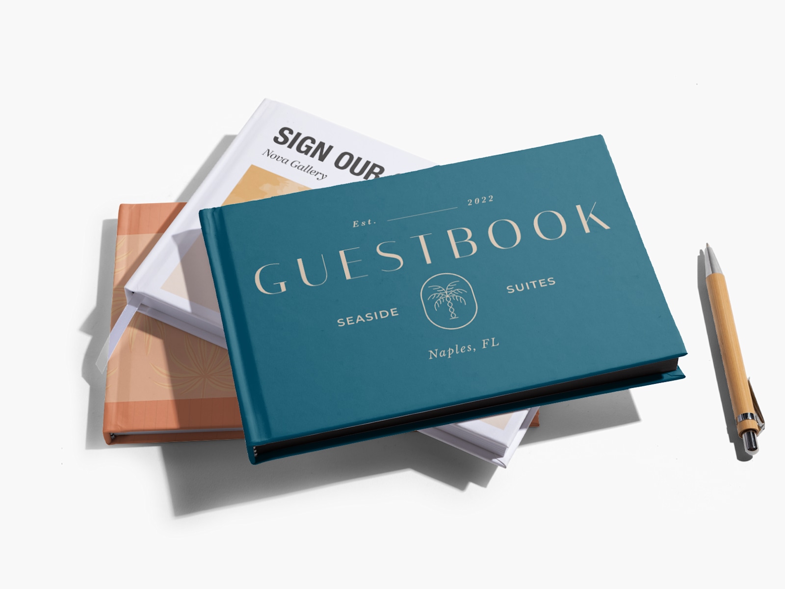 A stack of guest books, one printed with the name of a hotel on the cover and the other with the name of an art gallery. 