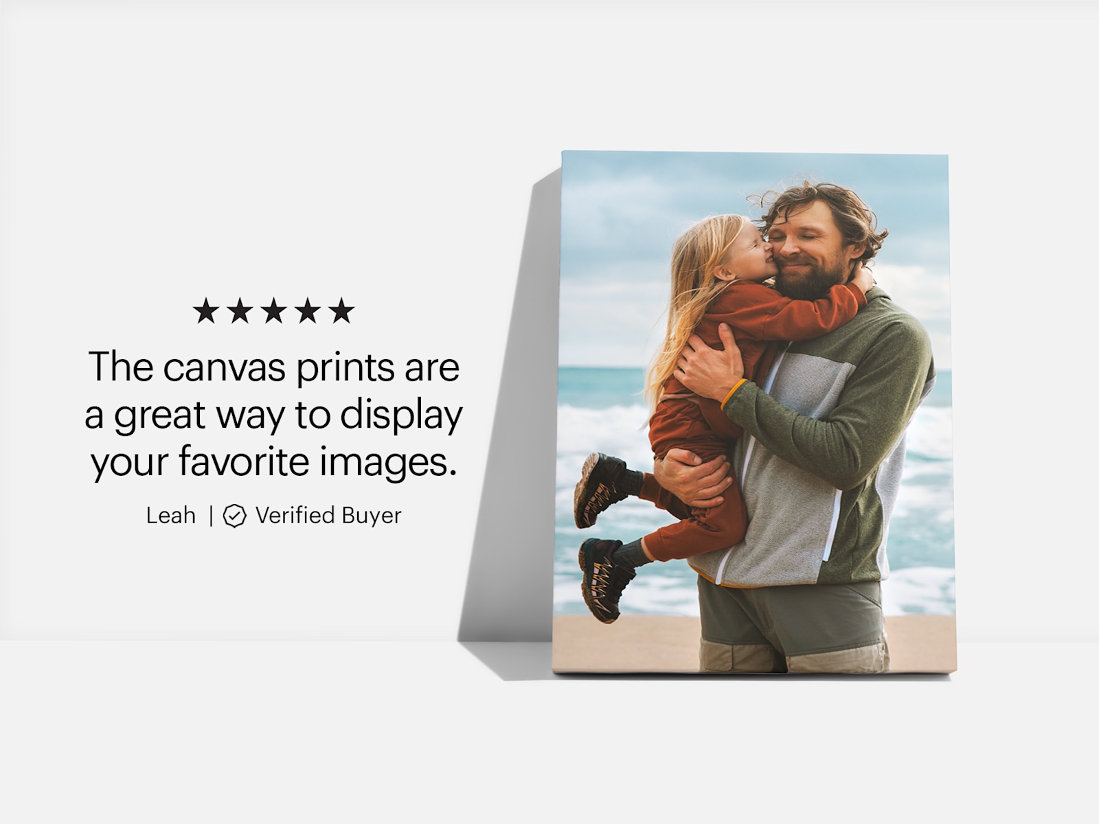 Two photo canvas prints hanging on the wall, one of them showing two kids, the other one is a dog photo 
