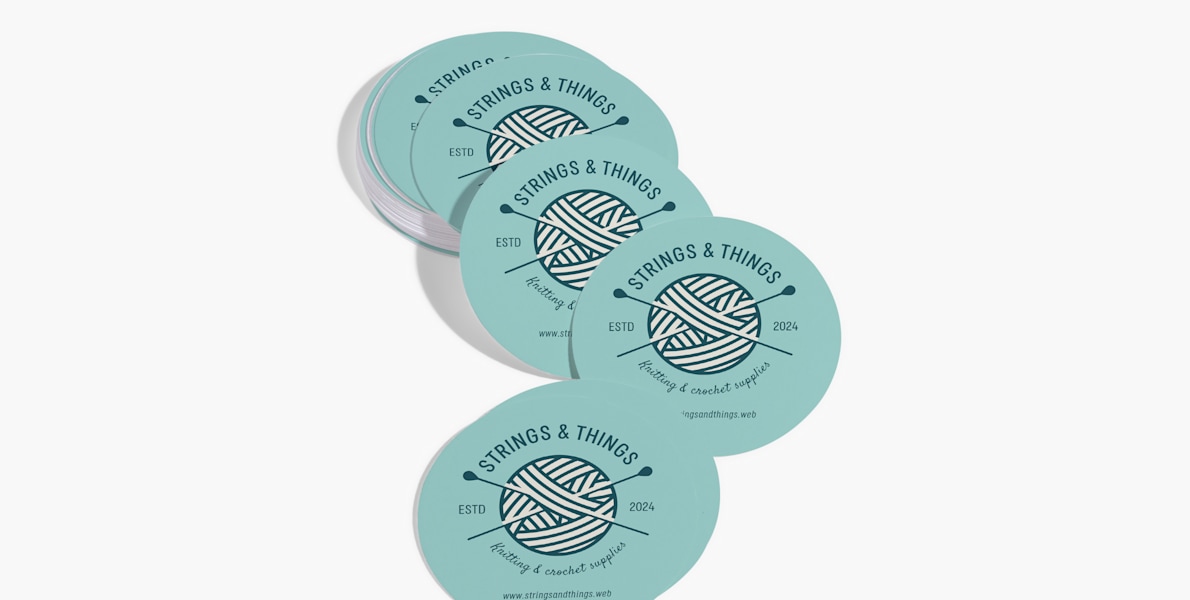 A stack of circle business cards for a knitting and crochet supply store.
