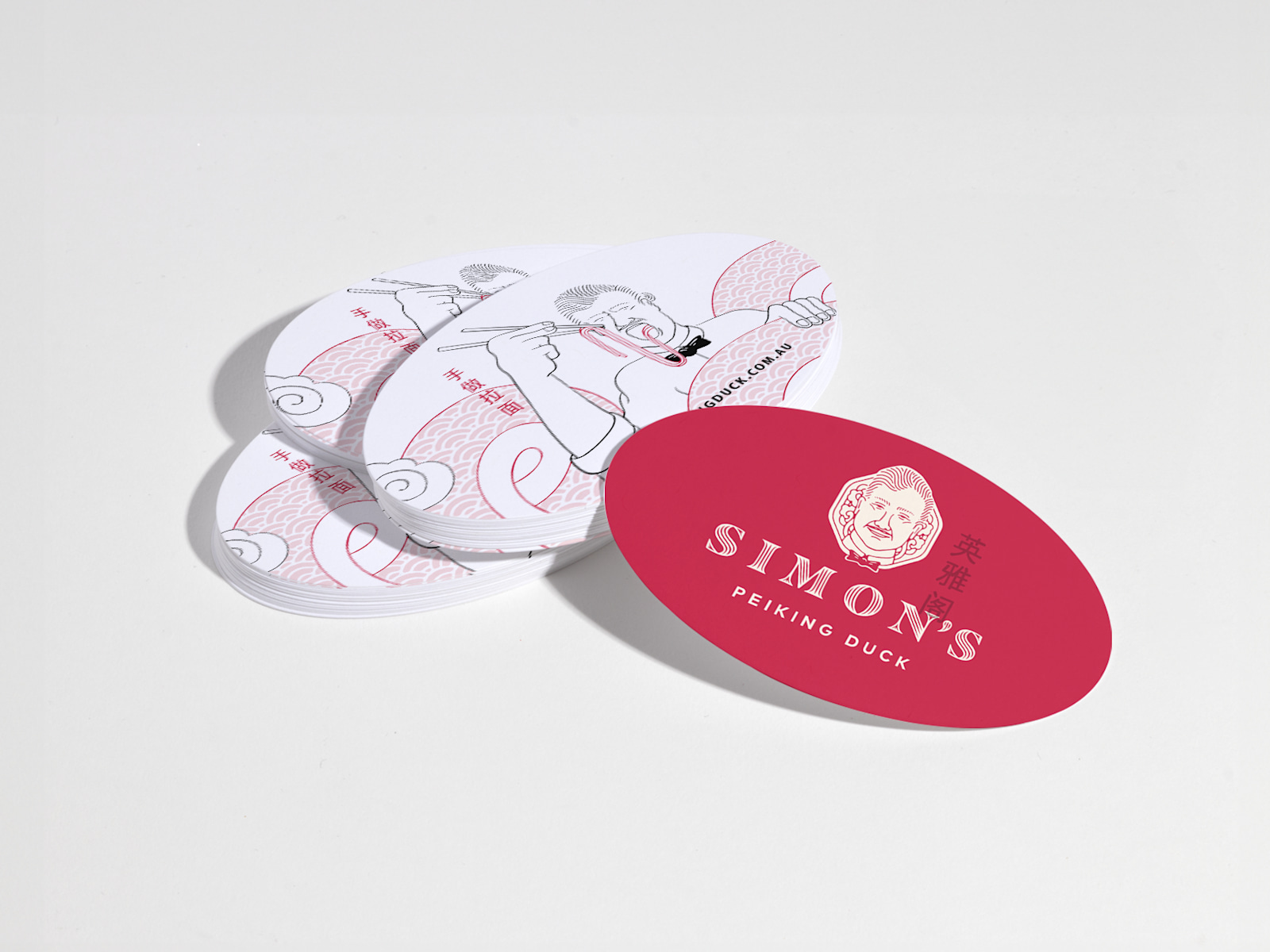 A stack of oval business cards for a restaurant, with front and back views.