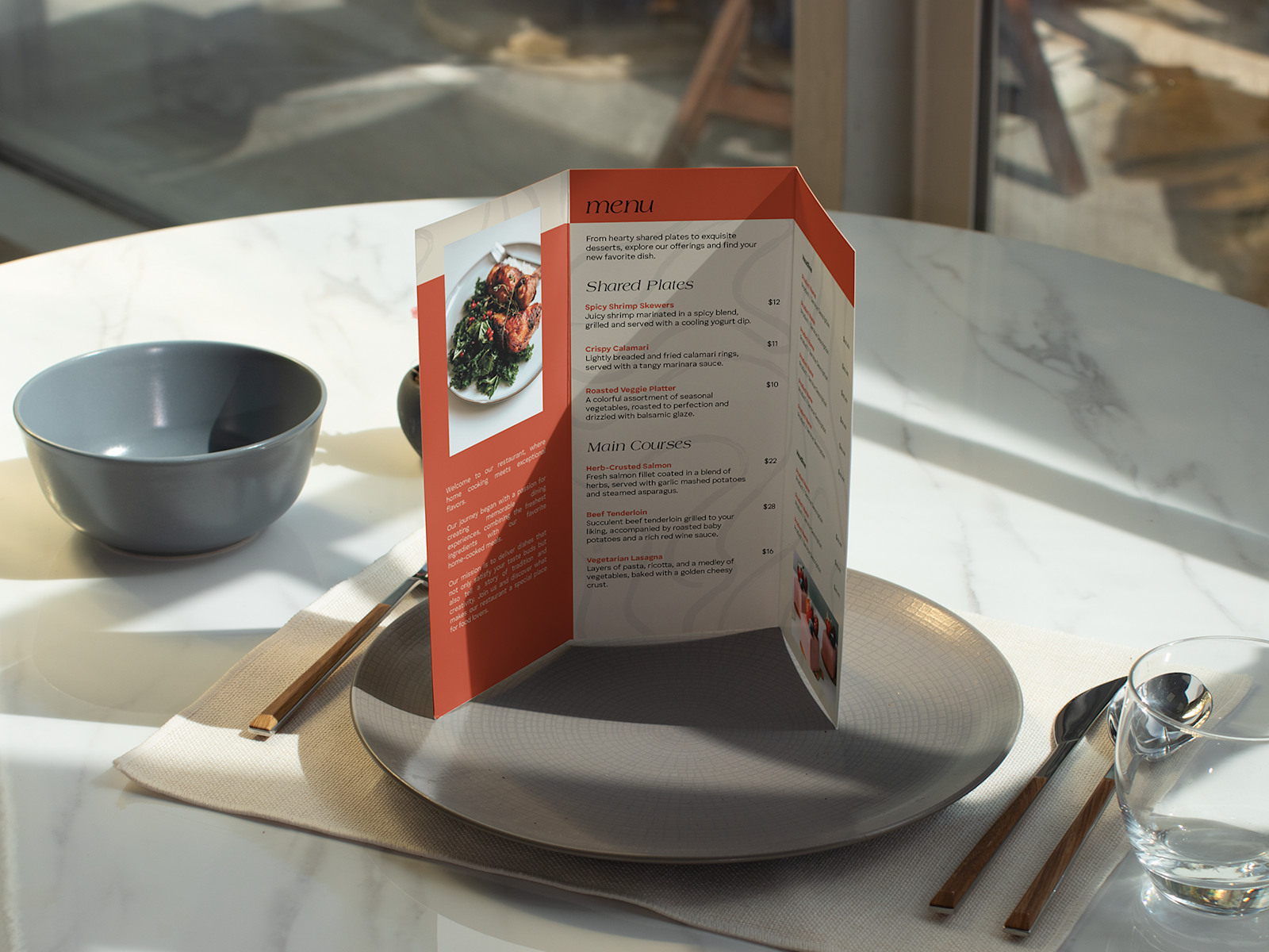 Larger version: An opened tri-fold menu, standing at a place setting at a restaurant.