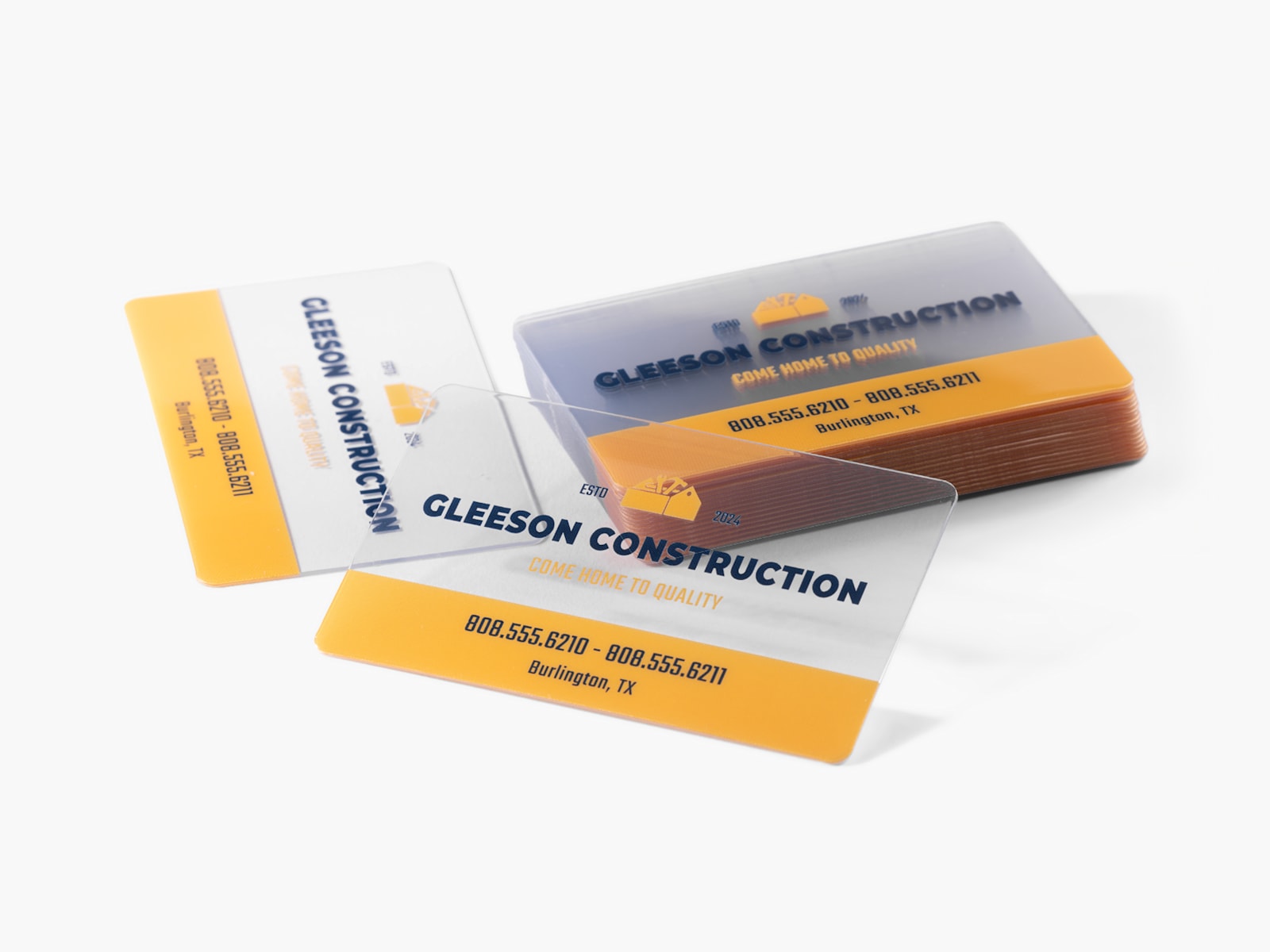A stack of clear plastic business cards for a construction business.