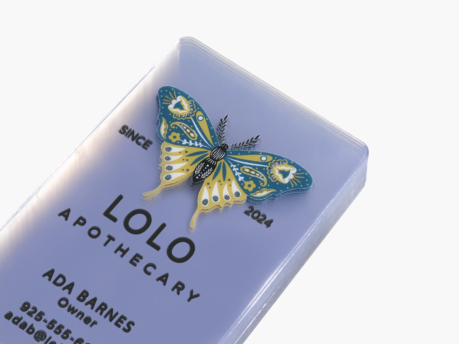 A stack of clear plastic business cards for a holistic health store owner.