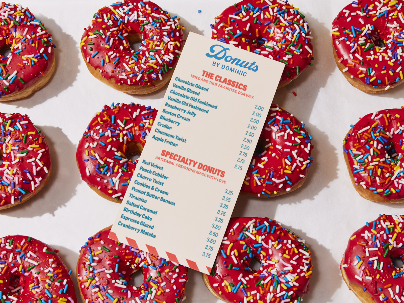 Larger version: A flat menu for a donut shop, resting on a sheet of freshly baked donuts.