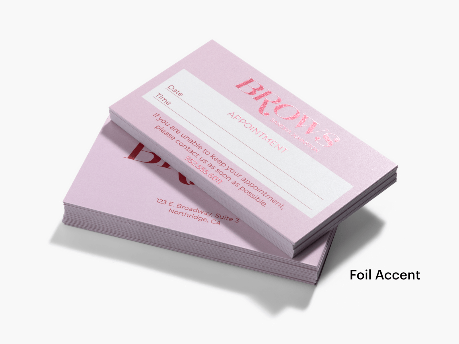 Two stacks of foil accent appointment cards for a beauty business, one showing the front and one showing the back.