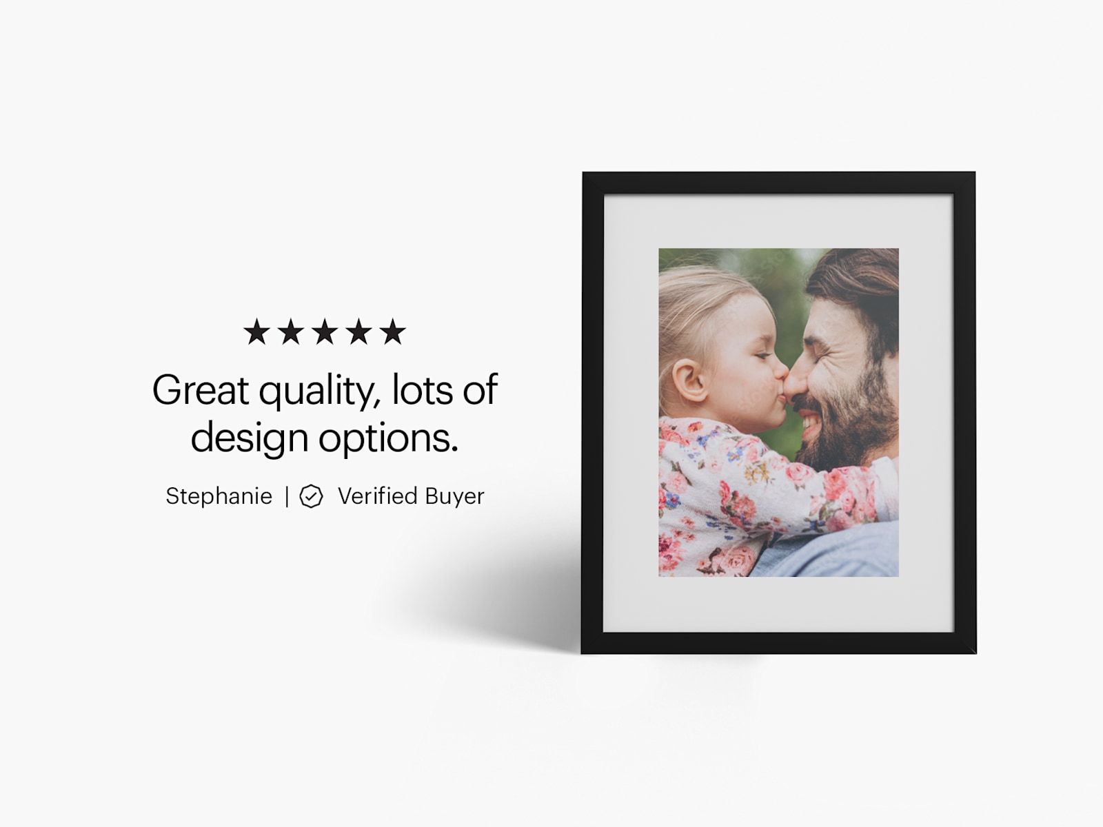 A framed print featuring a photo of a child and man hugging. 