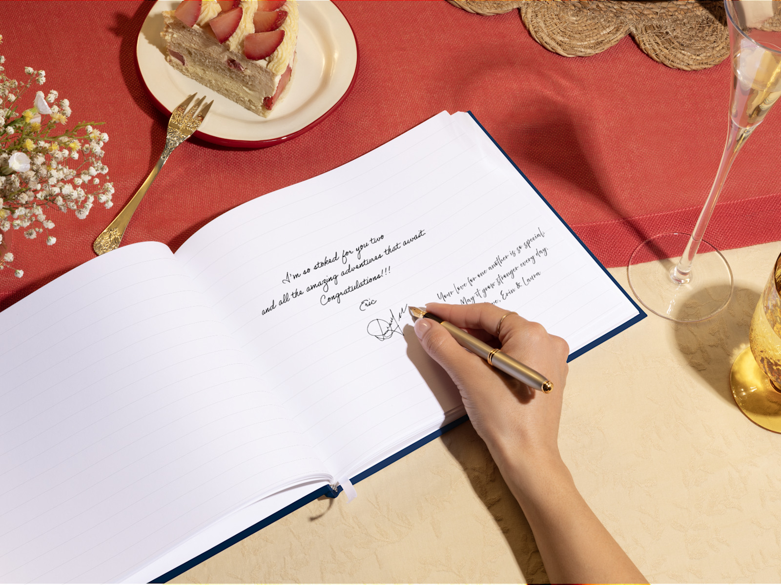 A hand signing an open guest book. 