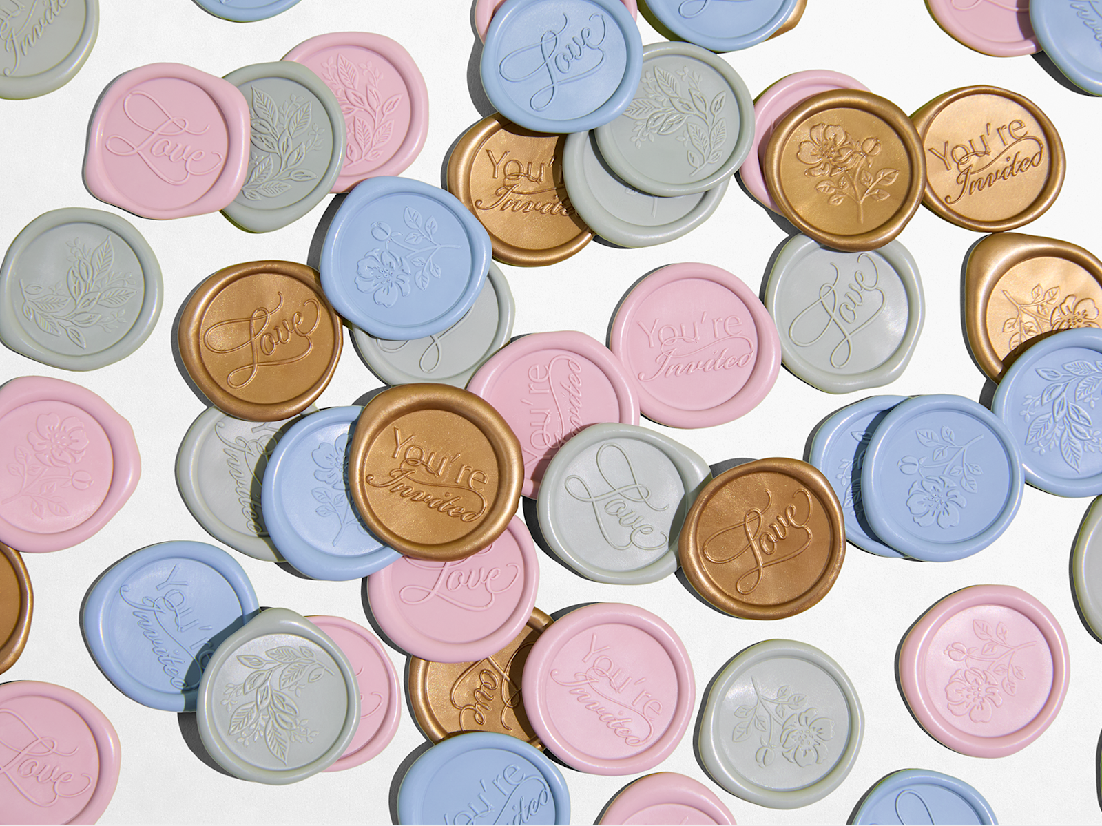 A pile of custom wax seals in a variety of colors and motifs. 