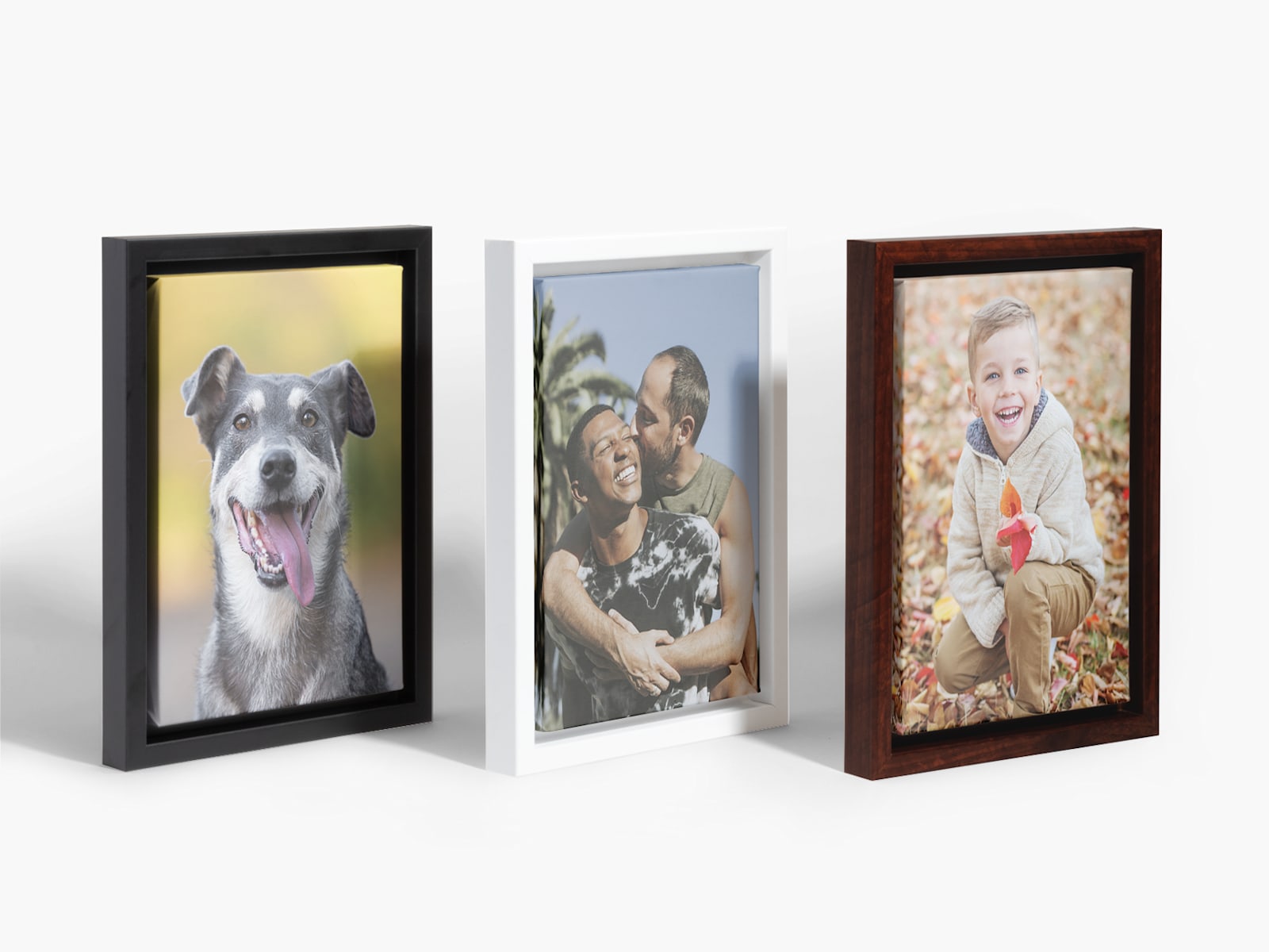 A trio of framed photo canvases, which with a different frame color. 
