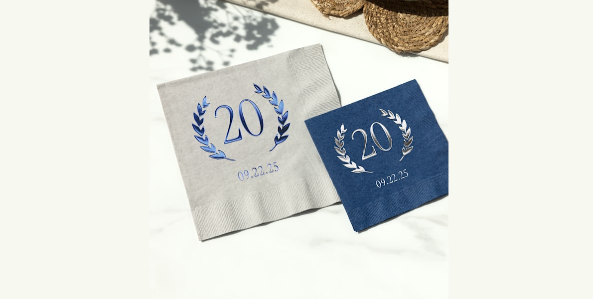 Larger version: Two foil napkins for a birthday, one featuring blue foil and the other featuring silver foil. 