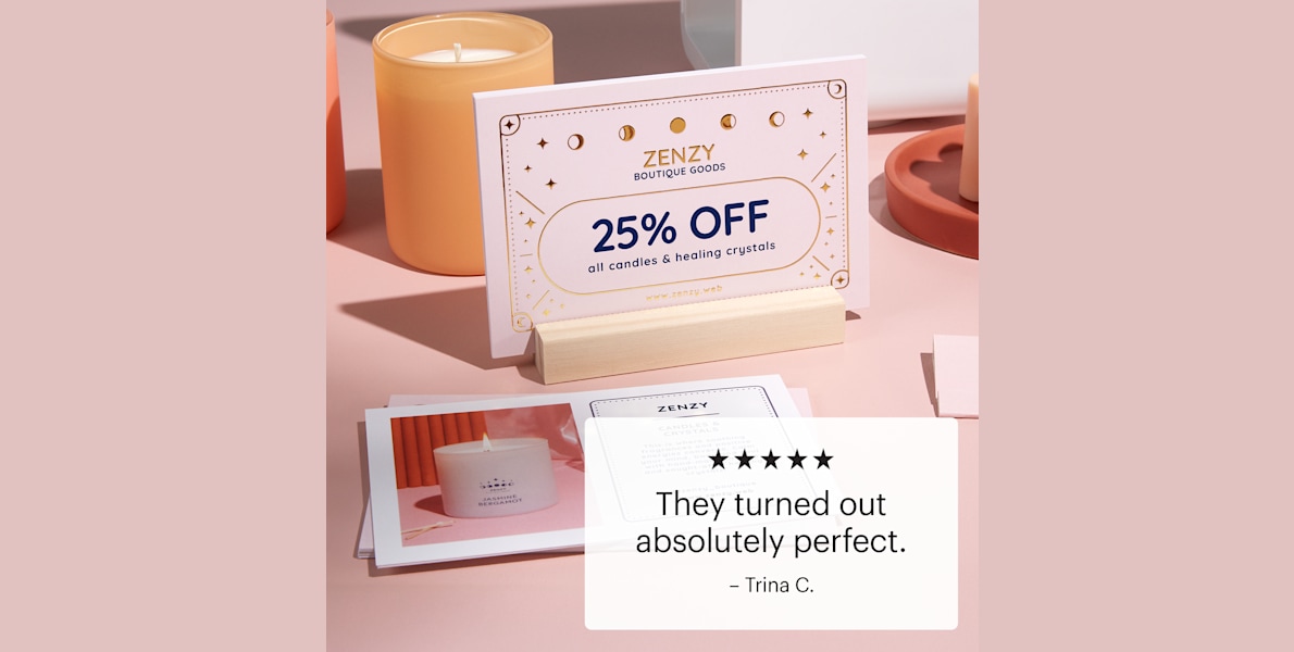 A raised foil postcard in a wooden holder on a display counter.