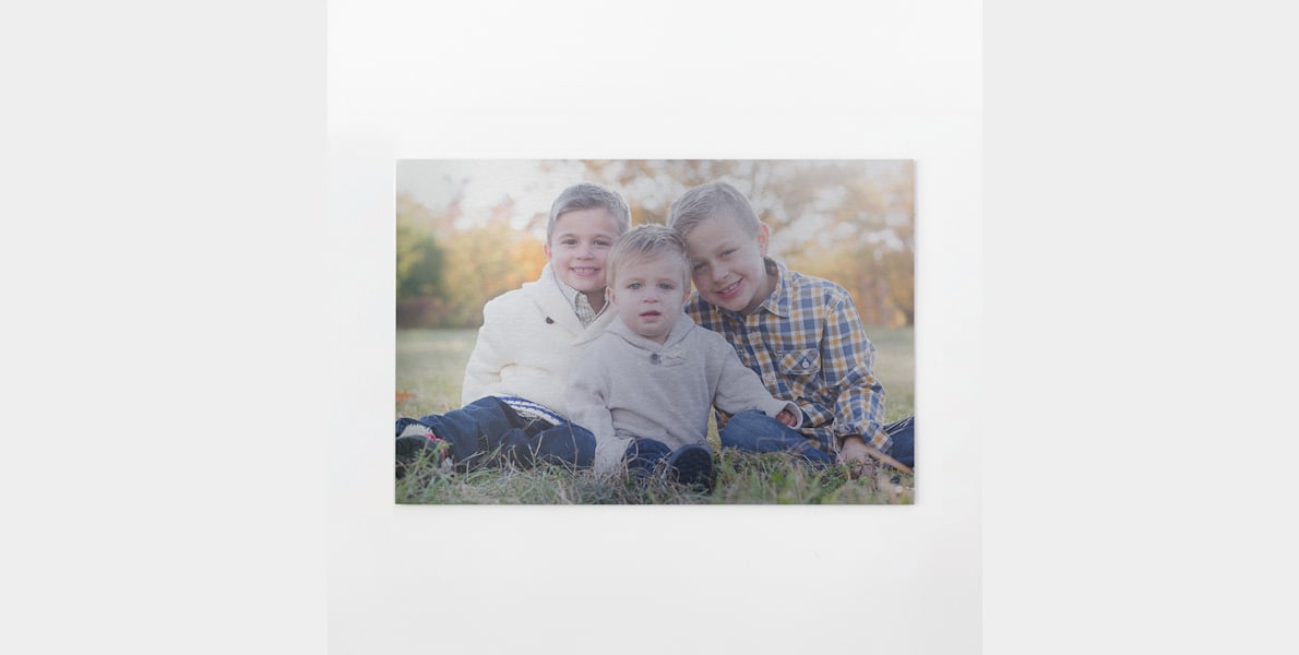 An aluminium print featuring three kids.