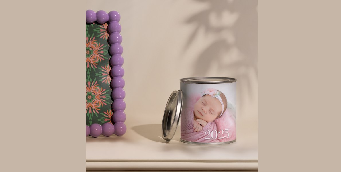 Een gepersonaliseerde kaars bedrukt met een foto van een baby en het jaar 2025. 