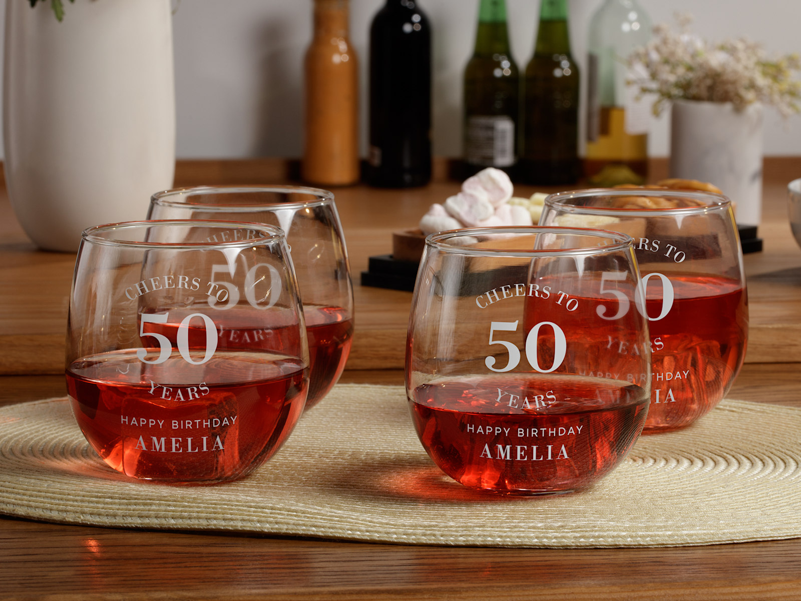 4 stemless wine glasses personalised for a 50th birthday party.