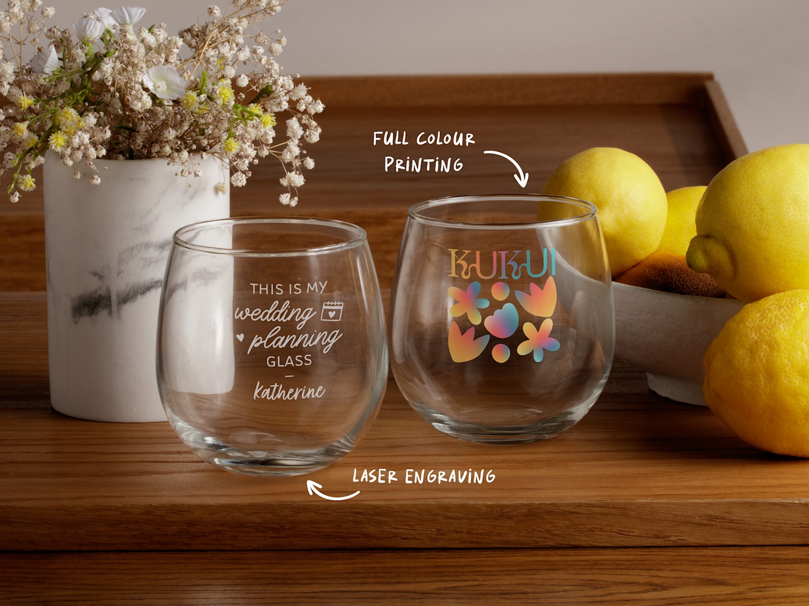 Two glasses, one with a design showing laser engraving and the other showing full-colour printing.