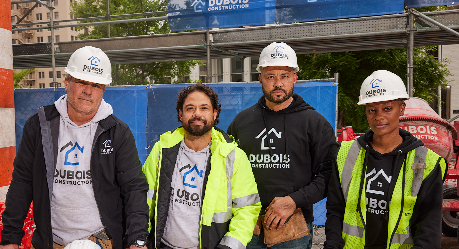 A construction crew wearing branded hoodies and hard hats.