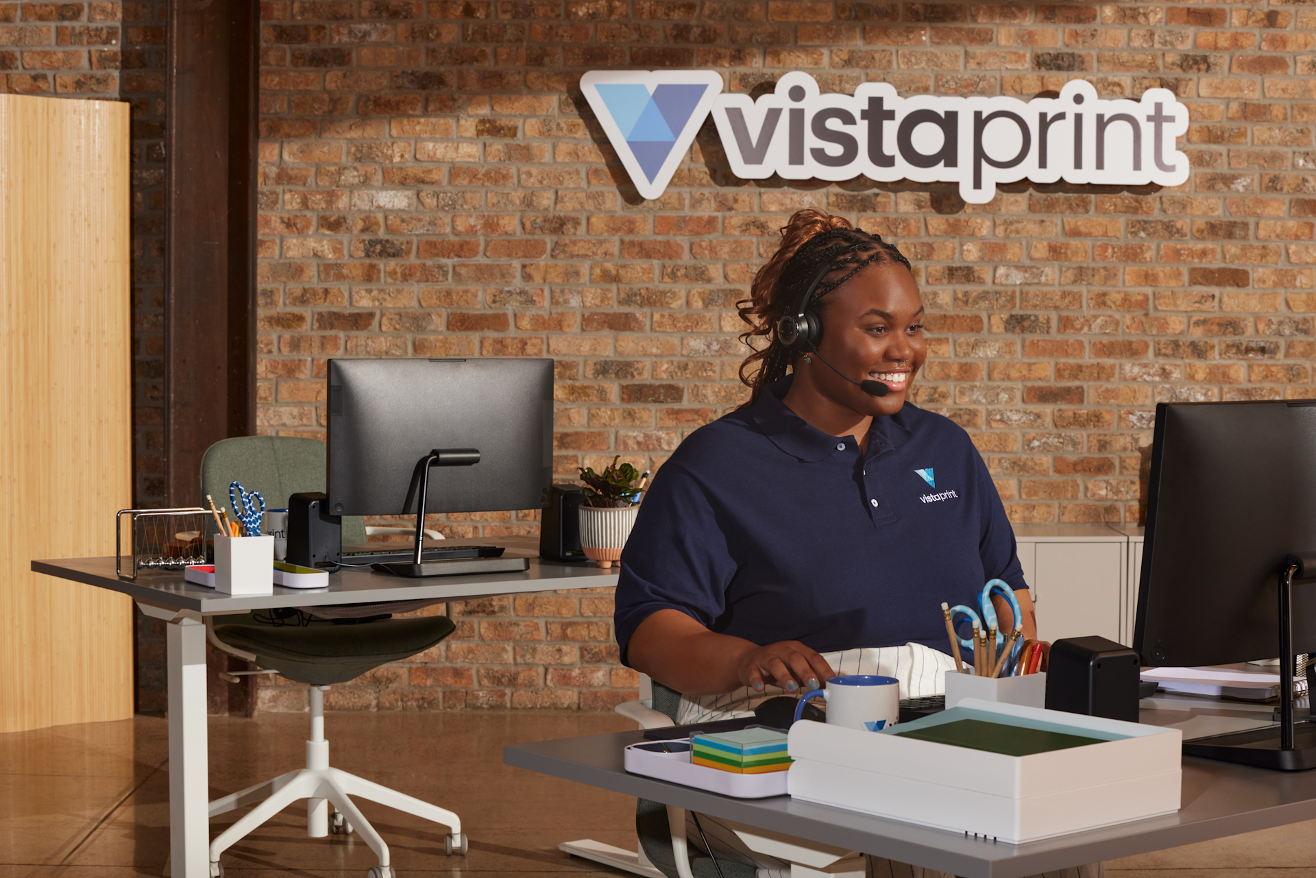 A VistaPrint care specialist helping a booklets customer.