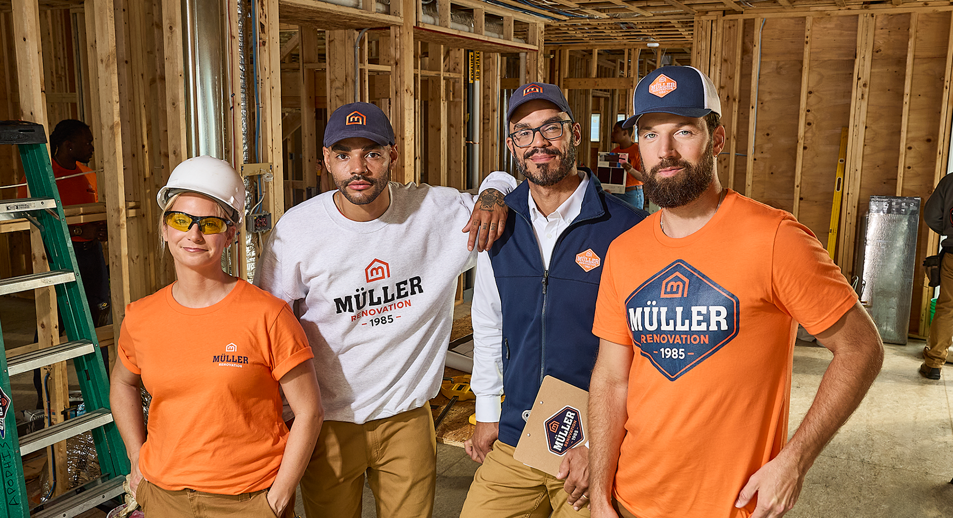 A team wearing branded clothing and hats for a renovation business.