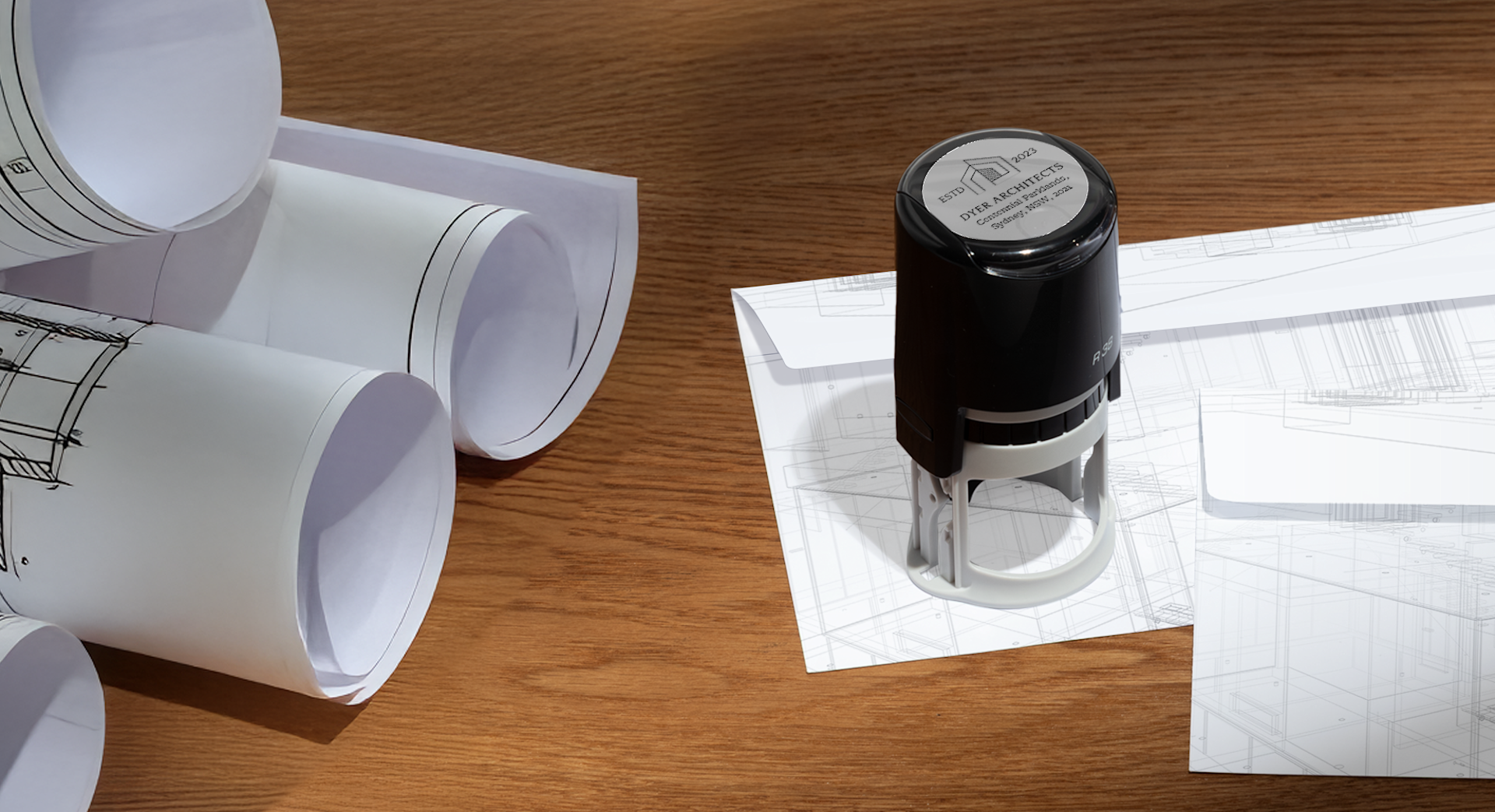 A circle stamp of a personalised monogram, marking a letterhead.