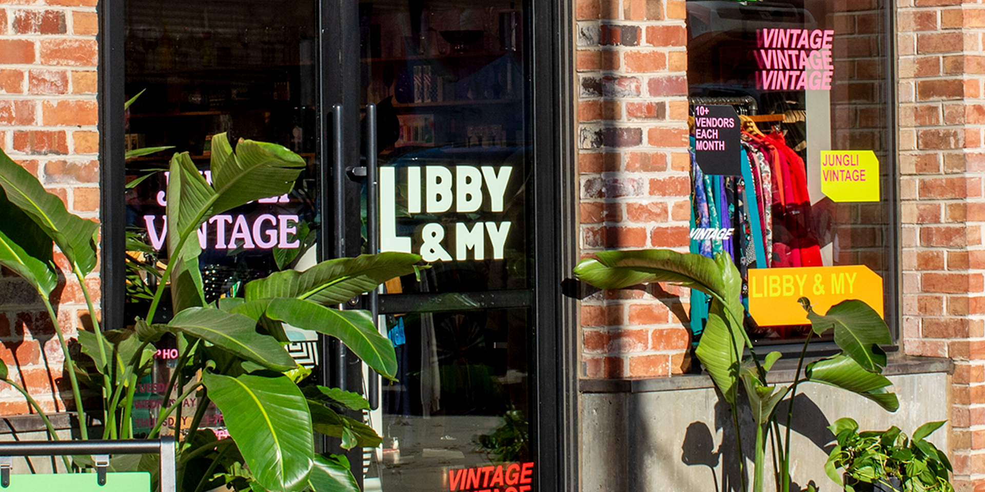  A vintage retail shop, with colorful window decals on the shop windows.