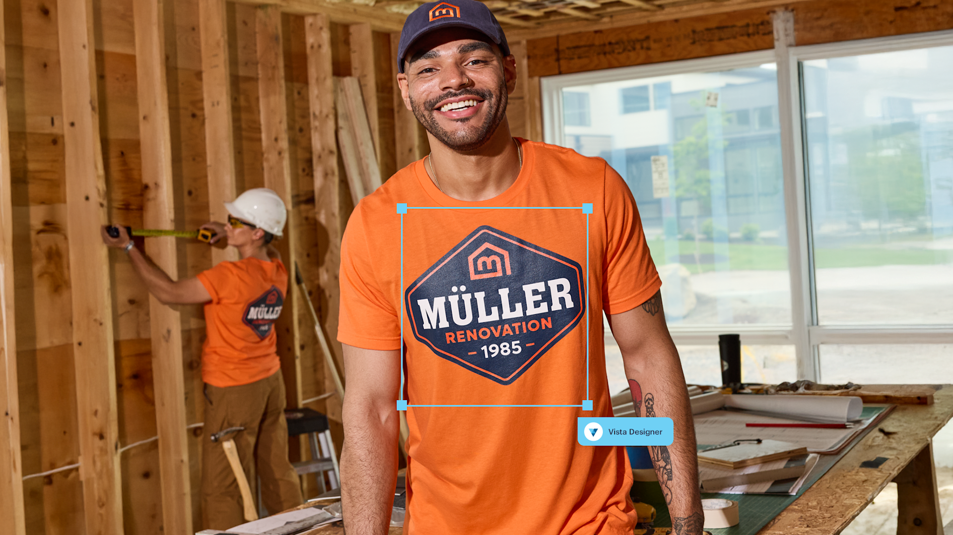 A construction worker wearing a custom T-shirt with the logo being customized.