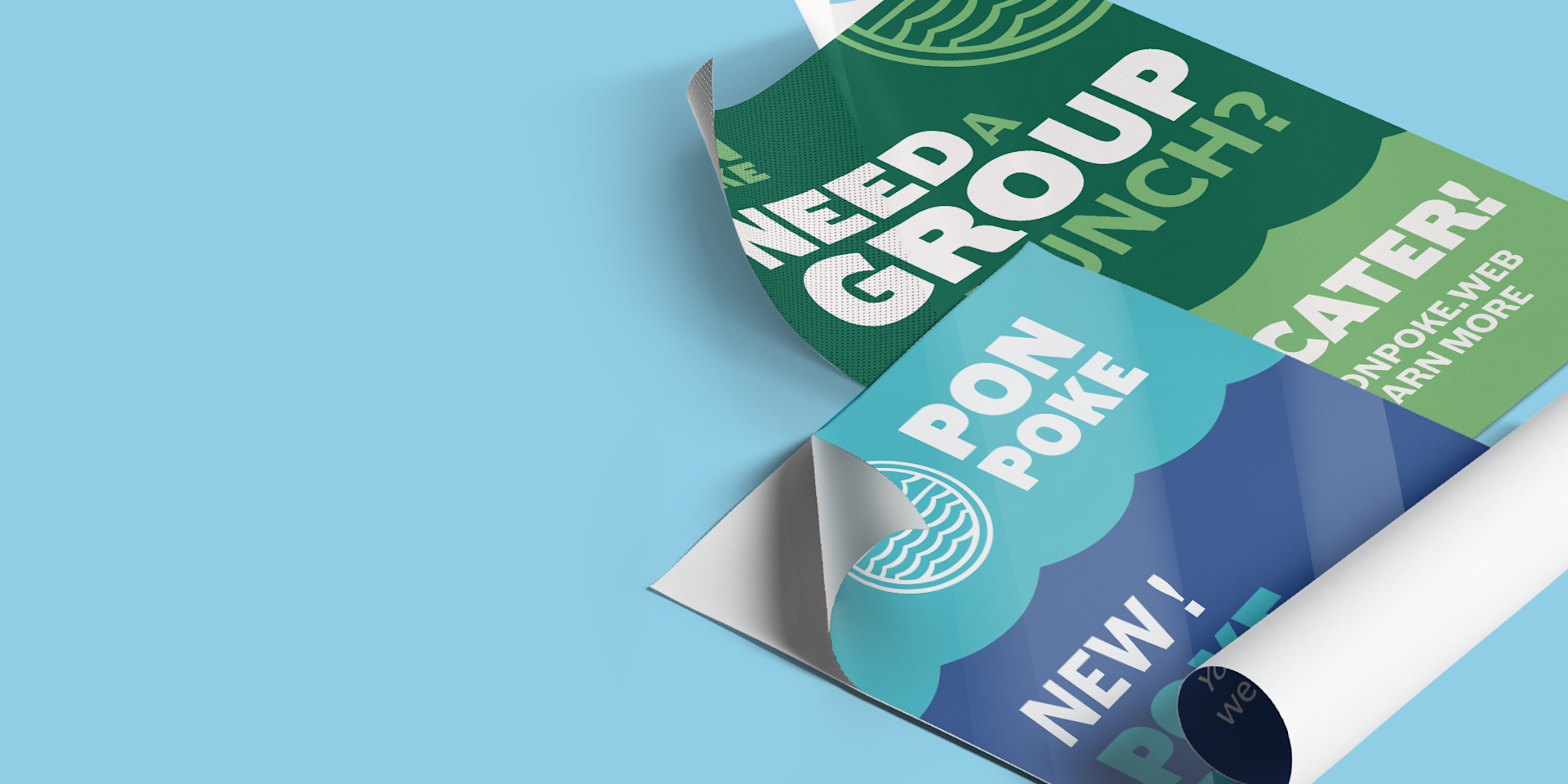 Two custom posters rolled out on a blue background.